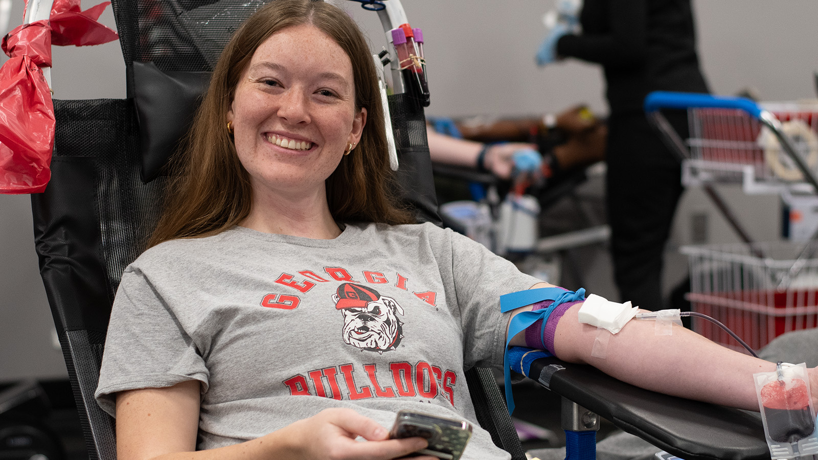 Happy donor giving blood