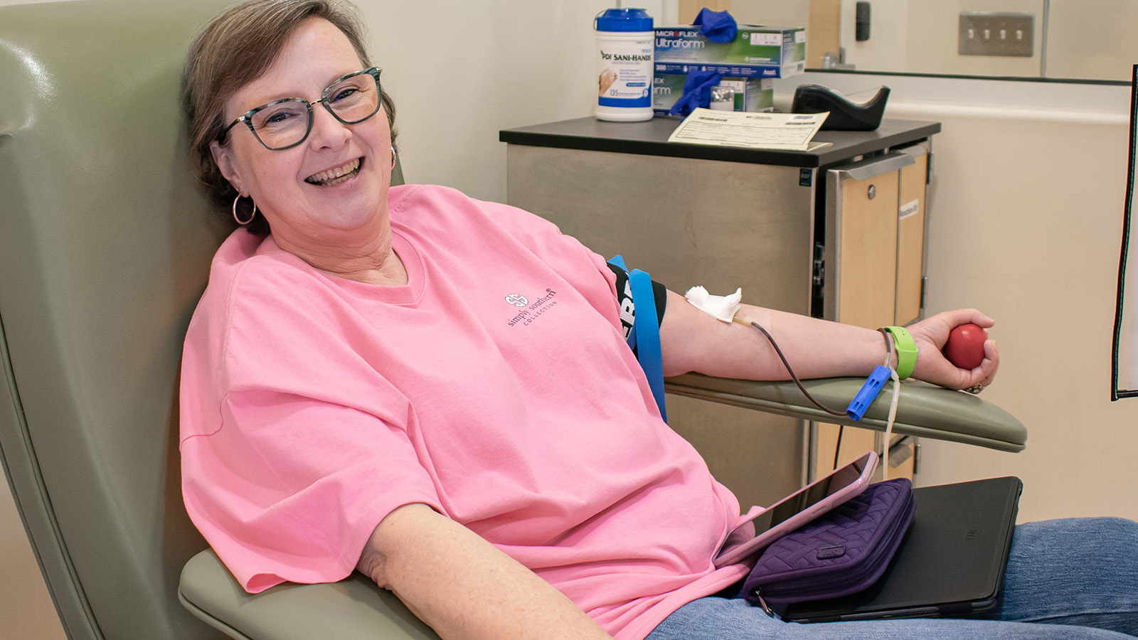 Happy donor giving blood