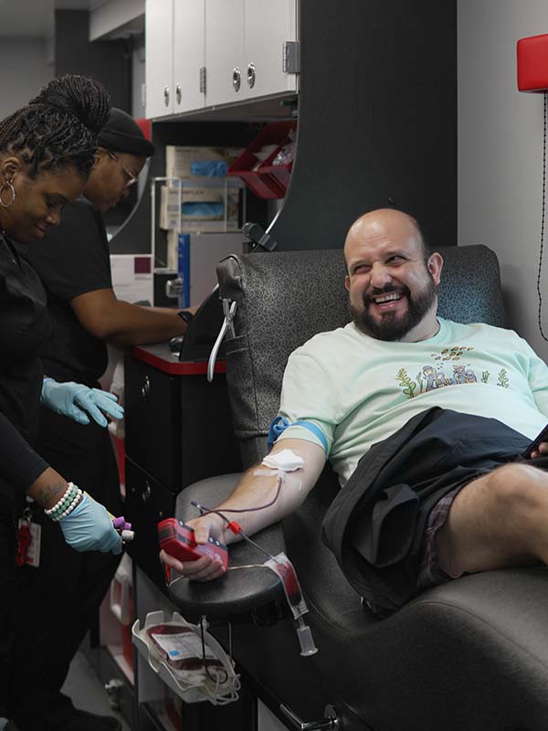 Happy donor giving blood