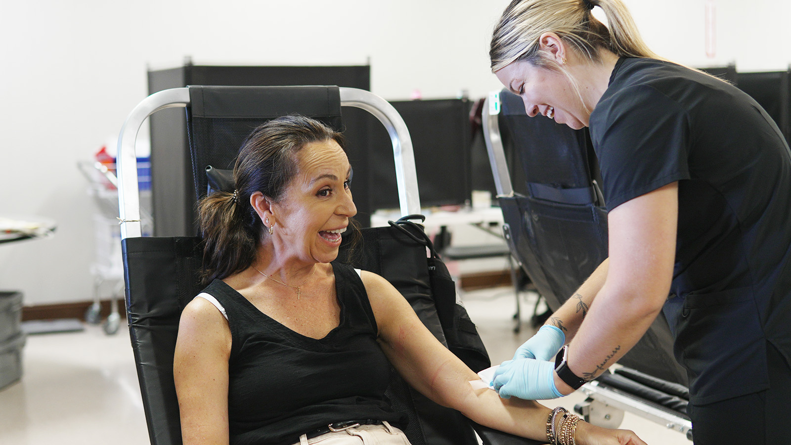 TBC staff with donor giving blood