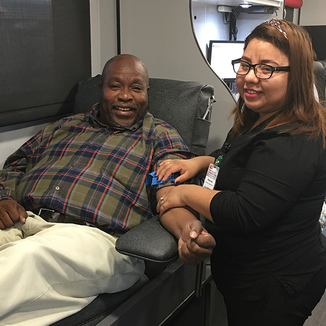 TBC employees assisting a donor